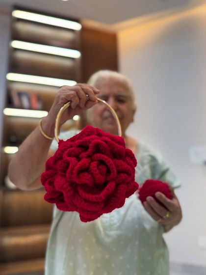 The yarn versus the final product. It's amazing to see a simple ball of yarn transform into this stunning red Peony Bag.
