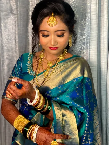 This shot shows the intricate details of Priyanka's jewelry and how the makeup tones were chosen to harmonize with the gold and the colors of her saree.