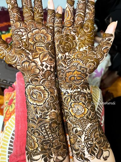 This design is a beautiful example of a floral-heavy pattern, with different types of flowers and leaves creating a lush, garden-like effect on the arms.