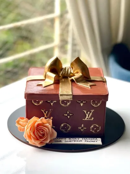 For the fashion lover, a cake that's as luxurious as the brand that inspired it. This Louis Vuitton gift box cake is all edible, right down to the gold monogram details and the bow.