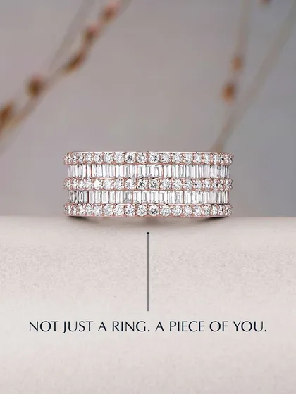 Not just a ring, but a piece of you. This wide eternity band is meticulously set with multiple rows of baguette and round diamonds, creating a statement of pure brilliance and sophisticated design. It is a testament to masterful craftsmanship.