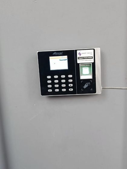 A duplicate image showing the biometric attendance machine installed at the Kanpur gym, highlighting its sleek design against the wall.