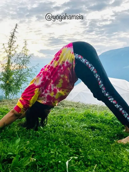 This is a demonstration of Parvatasana (Mountain Pose), a foundational pose that stretches the entire body. It's particularly effective for relieving stiffness in the shoulders and back and improving blood flow to the brain.