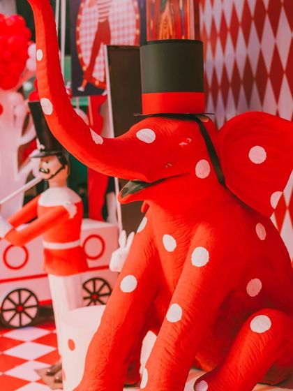 A close-up of the custom-made, polka-dotted red elephant prop. These large, handcrafted pieces are a signature of my events and make a huge visual impact.
