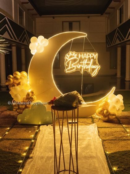 The warm glow of the moon backdrop and fairy lights creates an incredibly romantic and picturesque setting.