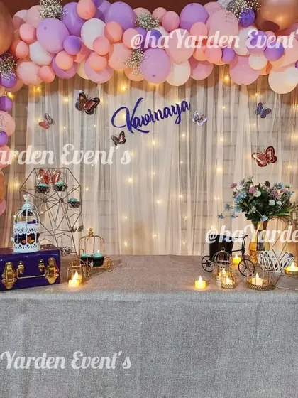 Another view of the pastel butterfly theme, showing the full table setup with delicate props.