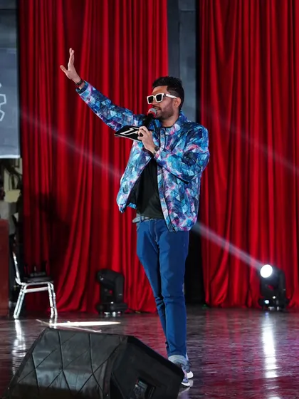 On stage is where I feel most alive. This shot captures the essence of my performance style: commanding, confident, and completely focused on connecting with every person in the audience.