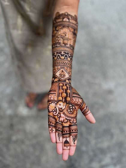 A single-arm view of the peacock and elephant design, showing the level of detail and craftsmanship that goes into each premium bridal mehendi.