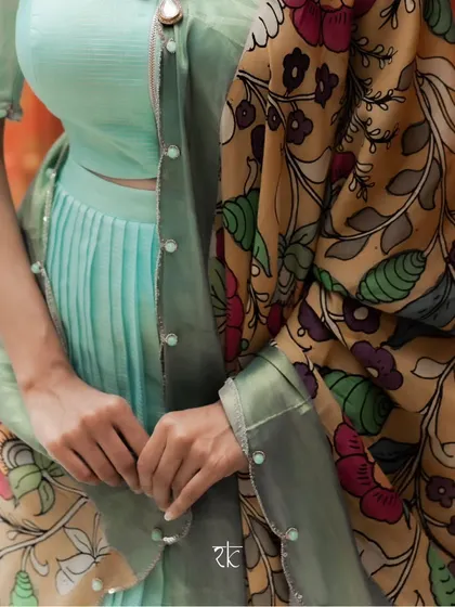 A closer view of the sea blue chanderi silk pleated lehenga set, showing the delicate pearl detailing on the dupatta border.