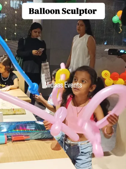 This little guest is thrilled with her balloon creations. The balloon sculptor not only provides entertainment but also gives each child a personalized toy to take home with them.