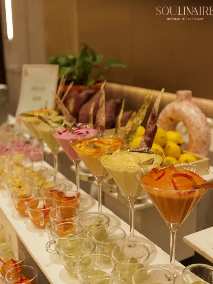 A colourful and inviting display of various dips and salads in martini glasses, showcasing our creative and modern approach to buffet presentation.