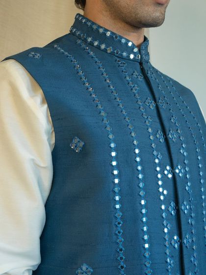 Our mirror work is done with precision, creating patterns that catch the light and add a festive sparkle to your ensemble.