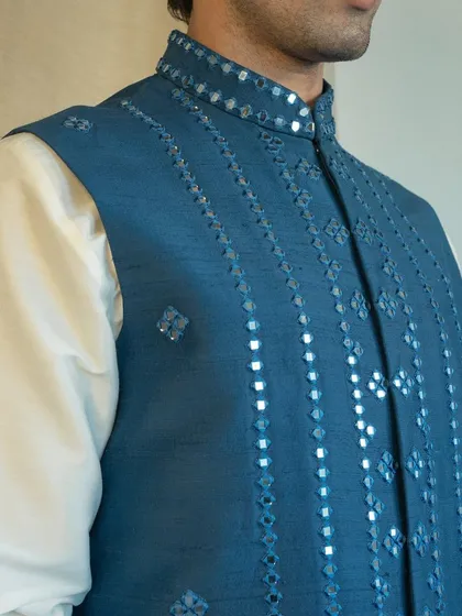 Our mirror work is done with precision, creating patterns that catch the light and add a festive sparkle to your ensemble.