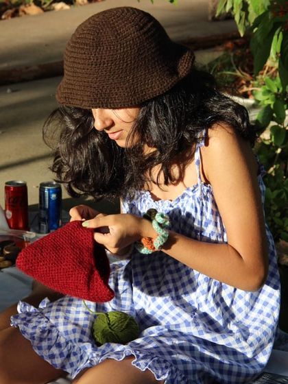 Even when I’m relaxing, I’m usually crocheting. Here I am wearing my brown bucket hat during a picnic.
