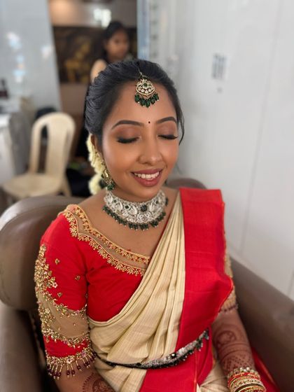Preethi with her eyes closed, highlighting the soft, shimmery eyeshadow and flawless base of her engagement makeup. The look is both gentle and glamorous, perfect for the occasion.