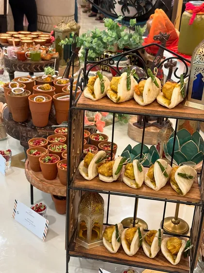A modern take on Indian street food for a Rakhi party. This tiered stand displays our innovative mini bao buns alongside chaat in traditional clay kulhads, offering a mix of contemporary and classic bites.