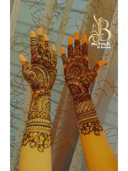 The beauty of a dark henna stain. This photo shows a fully developed color on a traditional design, featuring a mix of paisley, floral, and geometric elements.