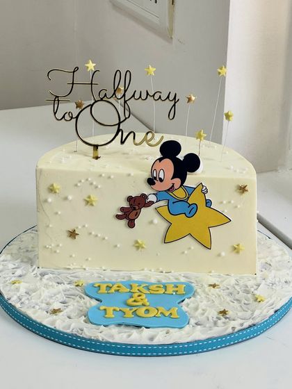 Celebrating the sweetest six months with this adorable Mickey-themed cake. It marks the "Halfway to One" milestone with dreamy stars and a classic character.