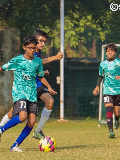 A player skillfully dribbles past an opponent, showcasing agility and quick footwork.