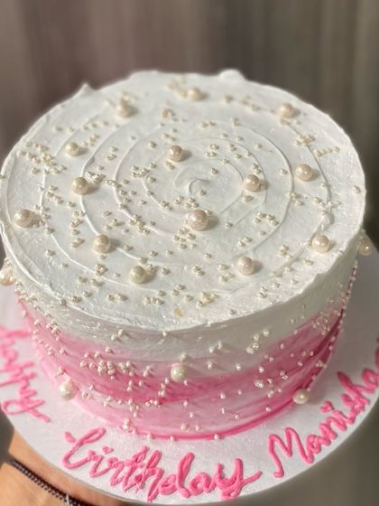 A top-down view of the beautifully sprinkled pink ombre cake.