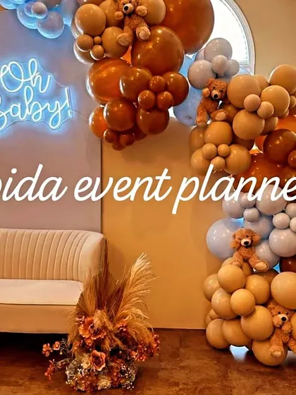 A close-up of our 'Oh Baby' neon sign against a backdrop, with teddy bears nestled into the balloon arrangements for a cute touch.