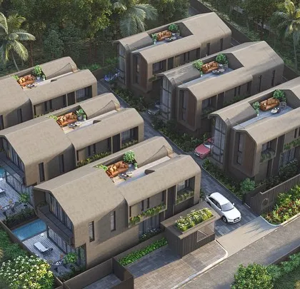 An aerial view of the Vagator Villas masterplan shows how each home is provided with a private pool and rooftop terrace. The repeating roof forms create a cohesive architectural rhythm while maintaining individual privacy.