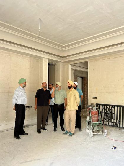 Our principals believe in being present on the ground. Here, our team is on-site at a residential project, having a discussion with the client. Walking through the space provides a clarity that drawings cannot, turning conversations into real-time decisions.