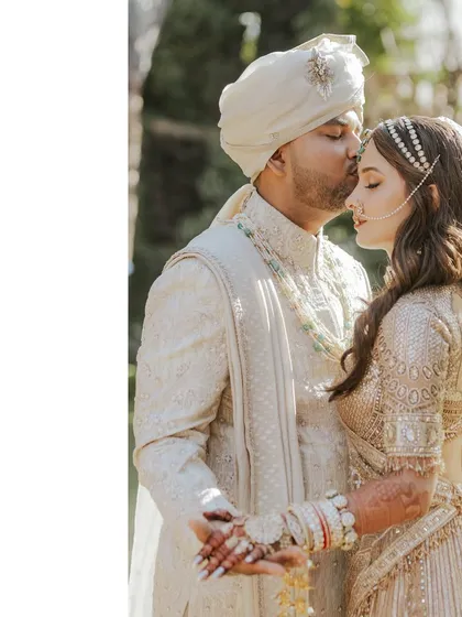 That final wedding day glow. This is the moment it's all about. Here, I worked with the couple to select timeless and elegant outfits that complemented each other perfectly, focusing on intricate details like the groom's custom sherwani and the bride's delicate jewelry to complete their vision.