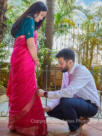Capturing the small, caring gestures is part of our storytelling. This candid moment of him helping with her saree is a beautiful detail in their love story.