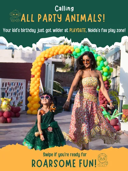 A stylish mom and daughter duo arriving at our safari-themed party. The colorful balloon arch at the entrance makes for a perfect first photo op.