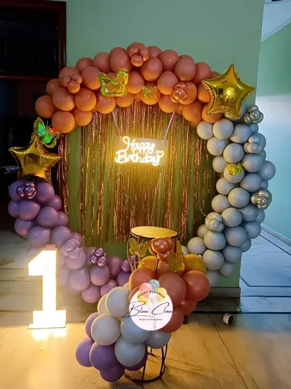 A unique three-toned balloon ring in pastel purple, grey, and orange for a first birthday.
