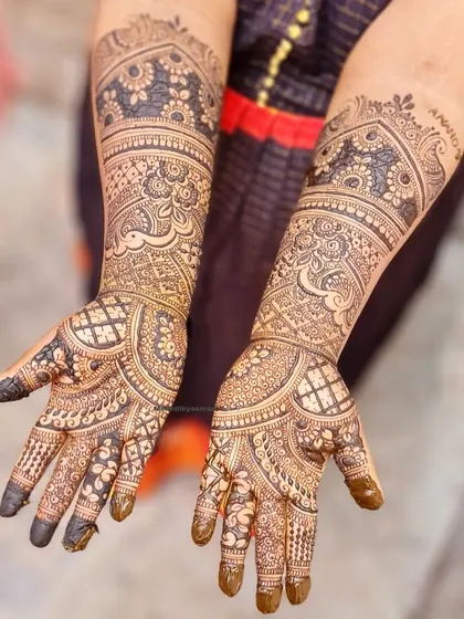 This design for the bride's sister is just as intricate as a bridal piece, featuring beautiful peacocks and detailed patterns.