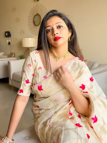 A close-up portrait capturing the essence of the Subho Bijoya look. The gold jewelry and red lip are classic festive choices.