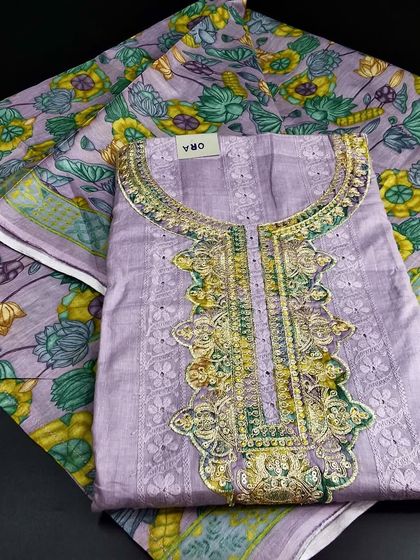 A beautiful Mangalgiri cotton dress material in a pastel purple shade. The intricate embroidery on the neckline and the printed dupatta make it a lovely choice for festive wear.