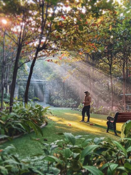 A beautiful shot of me in a park with sun rays breaking through the trees. A behind-the-scenes moment that feels as magical as the final footage.