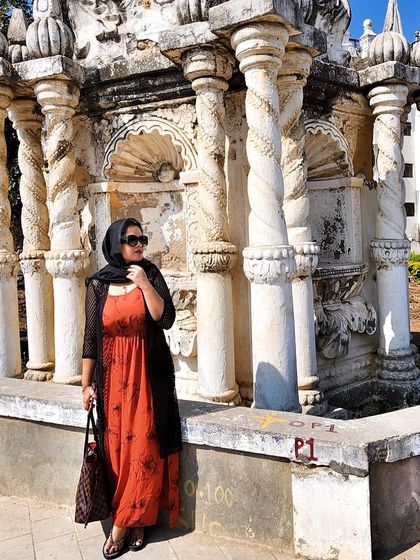 Posing against the beautiful baroque architecture of the church in Diu. The outfit's colors complement the historic setting.