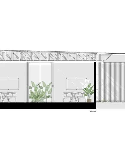 A sectional drawing focusing on the office and workspace areas within the experience center. It details the furniture layout and the visual connection to the outside through the large glass facade.