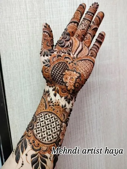 The details on the fingers are just as important as the main design. Here you can see the intricate patterns that complete the bridal look.