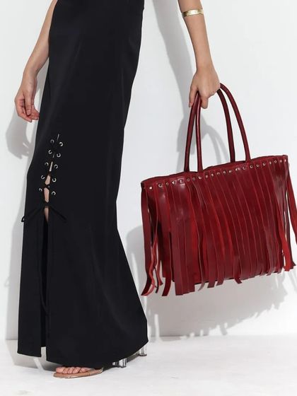 The Tango Tassel Tote in a striking blood-red. The dramatic tassels and spacious design make it a sophisticated and eye-catching choice.
