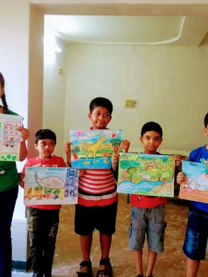 A group of our students proudly holding up their oil pastel drawings. It's wonderful to see the variety of subjects and styles they have created during their time in class.