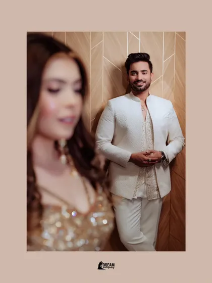 A creative shot of groom Puneet in focus, with his bride Rachita beautifully blurred in the foreground, telling a story of anticipation.