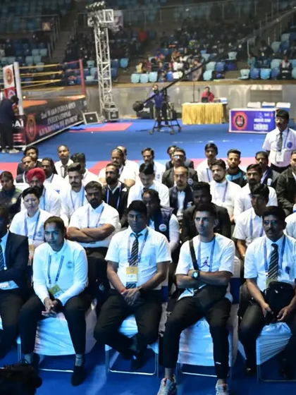 A wide view of the officials' seating area, with the competition floor in the background. We ensure our athletes are familiar with the formal environment of major tournaments.