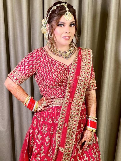 A three-quarter shot showing her confident pose and the beautiful detailing on her blouse and jewelry.