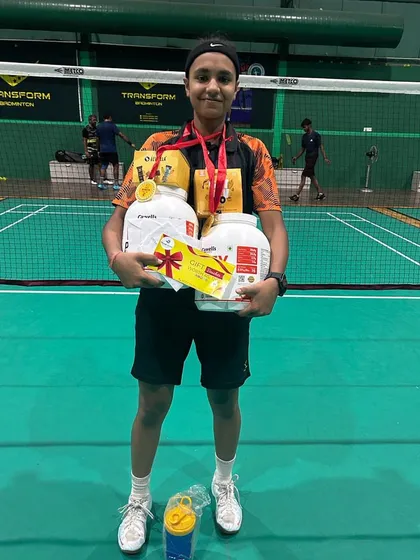 Sneha Kumar with her prizes after winning both the Girls Singles U-19 and Women's Singles titles at the Summer Badminton Challenge in Noida.