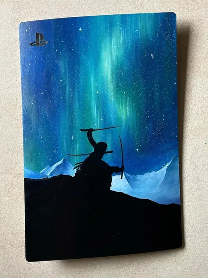 A 'One Piece' themed PS5 plate, featuring Zoro under the Northern Lights. This piece also glows in the dark, which is a super cool effect.