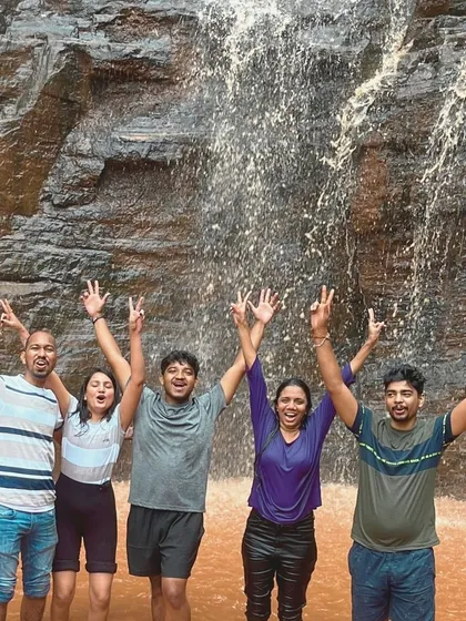 A group celebrating under a waterfall in Chikmagalur. These shared experiences of joy are what our community is all about.