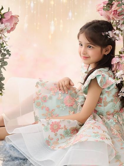 Another beautiful angle from our popular floral swing set. The soft, dreamy background and the girl's gentle expression create a portrait that is both sweet and artistic.