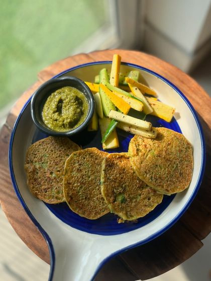 These zucchini fritters are a recipe from my book, 'Curve and Crave'. They are a delicious, low-carb, and healthy snack or meal option, served here with a fresh green chutney.