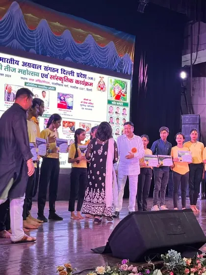 Our students receiving certificates and appreciation on stage at the Shah Auditorium for their performance during the Hariyali Teej festival. We encourage our students to share their passion for yoga.