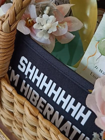 A fun detail from the hamper: a sleep mask that says 'Shhhhhh I'm Hibernating', a perfect gift for a new mom.